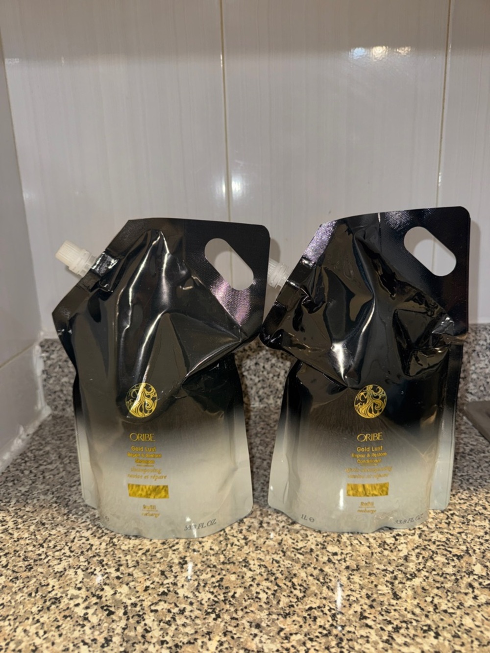 Oribe Gold Lust repair & restorative Duo Refill Pouches in Black and Gold